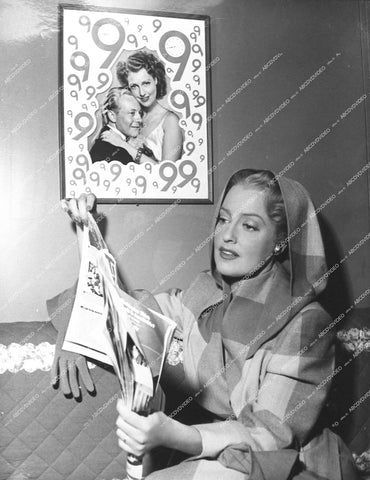 Jeanette MacDonald in her dressing room with 9 O'clock Gene Raymond poster on ger wall - 1948 film Three Daring Daughters - 0453-005