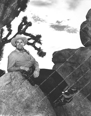Gene Autry sitting on the rocks - 1950 film Indian Territory - 0458-036