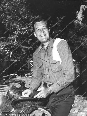 Charles Starrett cleaning his saddle - 0459-026