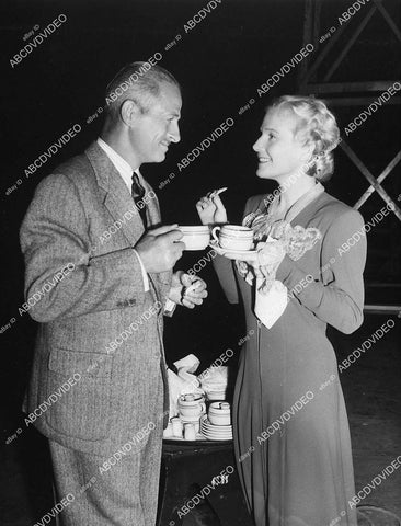 candid Reginald Denny & Ann Harding have coffee behind the scenes - 11006-010