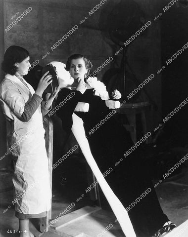 candid Diana Wynyard in wardrobe chair does makeup check - 11011-026