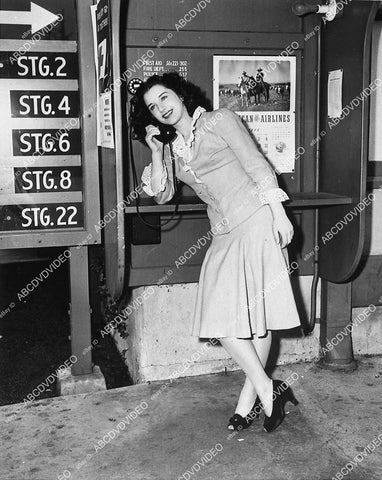 candid Marjorie Riordan takes telephone call on studio phone system - 11030-007