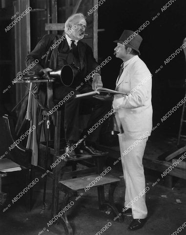 candid silent film star Theodore Roberts w director William Cowen in Cecil B DeMille's chair - 11030-015