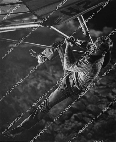 Rex Allen hanging from an airplane film Under Mexicali Stars - 11032-007