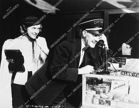 Ann Doran sneeks up on Charley Chase on telephone short subject film Many Sappy Returns - 11049-007