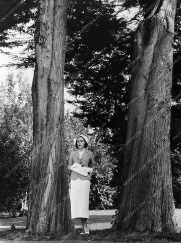 candid Dolores Del Rio out in nature between tall trees 593-25