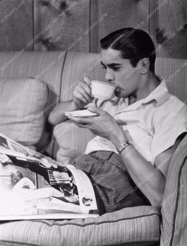 candid Tyrone Power relaxes with cup of coffee behind the scenes 738-22