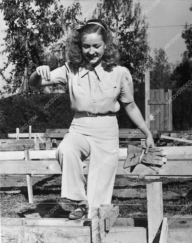 candid Bonita Granville feeding the animals on the farm 739-27