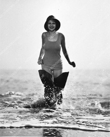 Irene Ware in her thigh high fishing boots standing in the waves 944-06