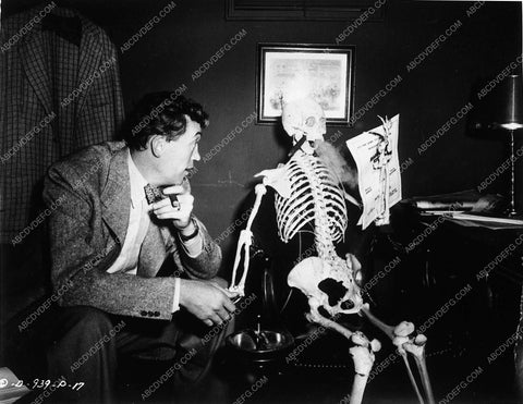 John Huston and skeleton enjoying a cigar behind the scenes 10128-18
