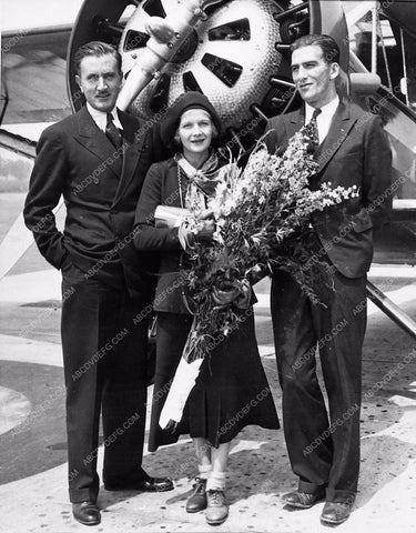 candid Ann Harding standing in front of airplane w flowers 1212-05