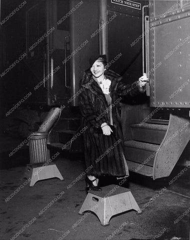 candid Claudette Colbert in fur boarding a train 1212-06