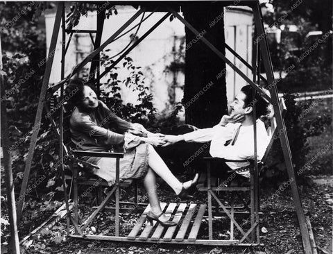 couple enjoying their glider swing in the front yard 1365-02