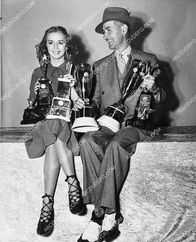 candid Anne Shirley and Charley Chase with some of their trophies 1501-17
