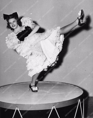 Judy Garland kicking up her heels on a large drum 1598-06