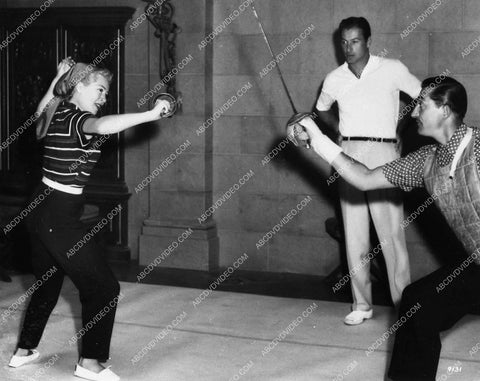 fencing master Jean Heremans teaches Lana Turner some moves Lex Barker watches 1626-19