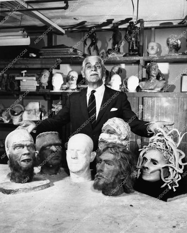Boris Karloff in prop fx dept w various monster heads 1645a-17