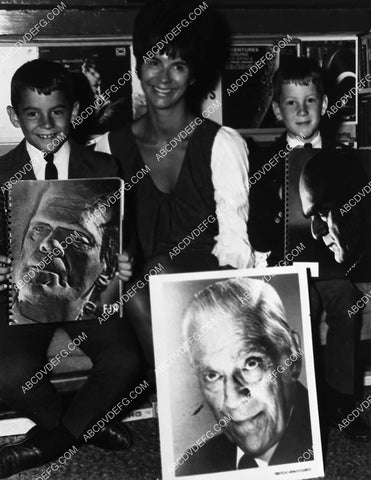 Forrest J Ackerman showing Boris Karloff poster to fans 1807-28