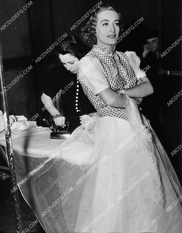 candid Joan Crawford gets her dress ironed between scenes at MGM Studios 1899-09