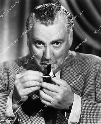 Nigel Bruce lighting his pipe film Rebecca 1939-32