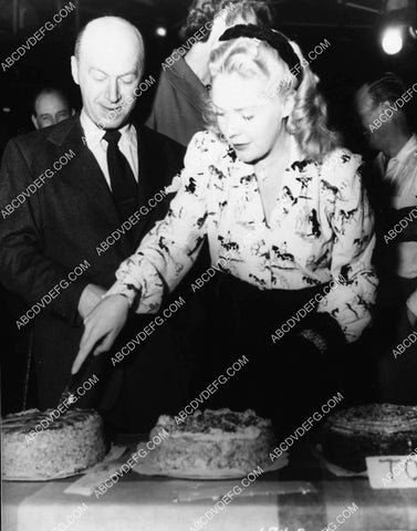 Alice Faye cuts birthday cake for Otto Preminger on set film Fallen Angel 2111-13