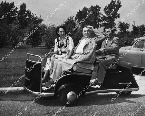 Bela Lugosi and wife on cool golf type cart 2112-22