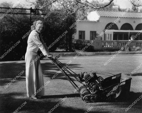 Alice Faye mowing the backyard grass 2120-10