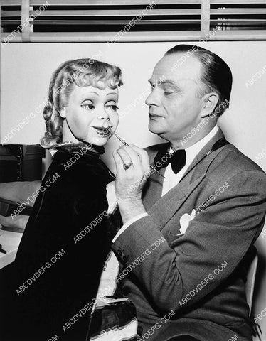 Edgar Bergen putting final makeup touches on ventriloquist dummy Podine Puffington 2132-27