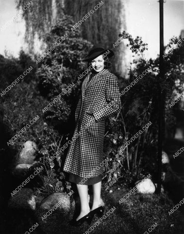 Lucille Ball posing in the garden in her new coat 2162-26
