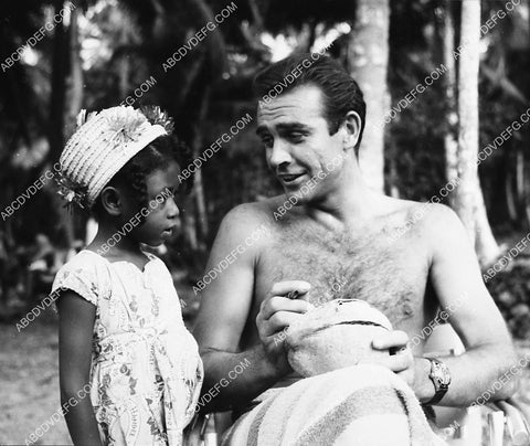 Sean Connery autographs a coconut for local girl on location film Dr No 2201-48