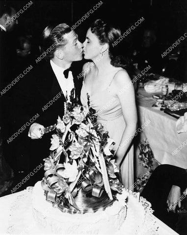 Judy Garland kisses Mickey Rooney over his birthday cake at Coconut Grove party 2351-02