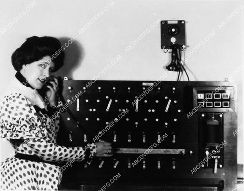 Blanche Le Claire using an 1878 wall telephone and switchboard 2373-21