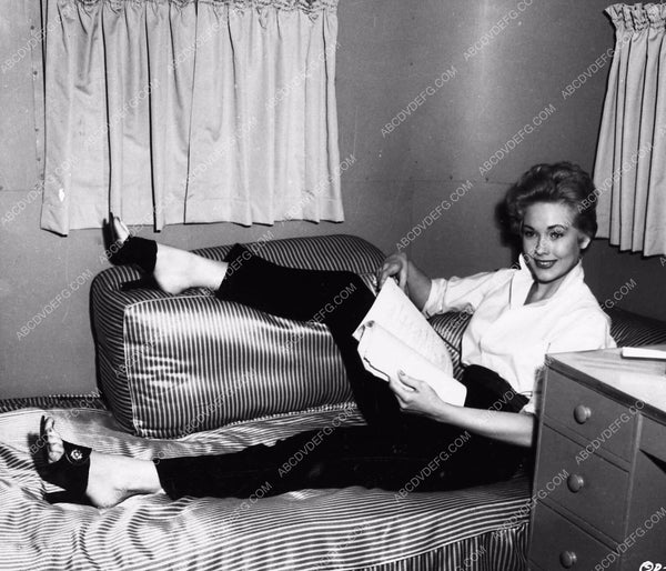 candid Kim Novak going over script in her dressing room behind the sce ...
