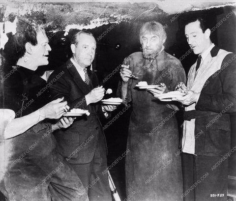 Basil Rathbone, Bela Lugosi watch Boris Karloff cut his cake behind the scenes 2707-27