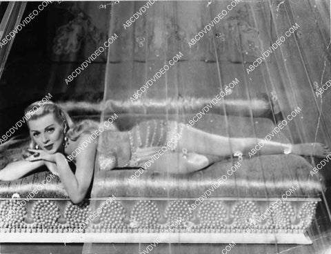 sexy Lana Turner laying in a veiled bed film The Prodigal 2753-28