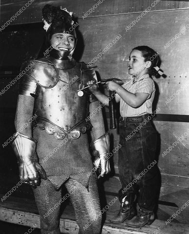 candid Louis Hayward gets medal hammered to suit of armor on set film The Black Arrow 2996-07