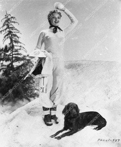 Betty Grable plays w her dog in the snow 3031-25