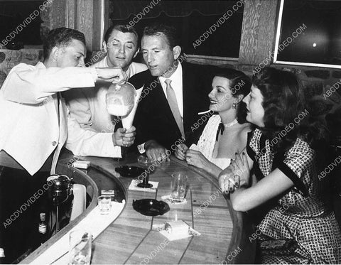 great candid Robert Mitchum Jane Russell Bob Waterfield have a drink at the bar 3105-24