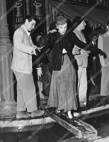 candid Judy Garland tries to keep her feet dry on set film Easter Parade 3176-11