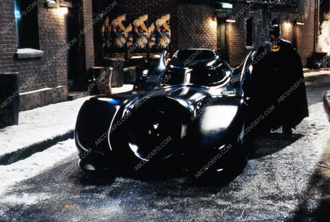 Michael Keaton as Batman standing next to Batmobile 35m-1162