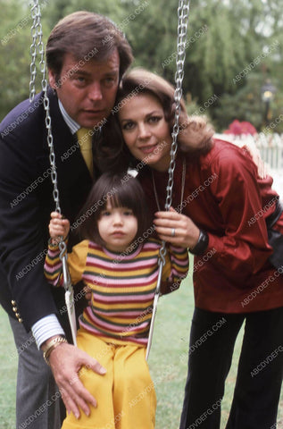 Natalie Wood and Robert Wagner play with the kids on the swings 35m-13103