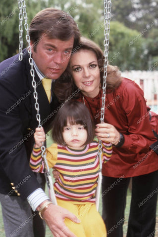Natalie Wood and Robert Wagner play with the kids on the swings 35m-13108