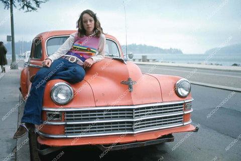 Mackenzie Phillips relaxing on the hood of a car 35m-16730