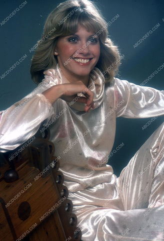 Olivia Newton-John sitting on a rocking horse 35m-5460