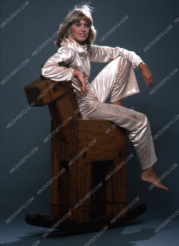 Olivia Newton-John sitting on a rocking horse 35m-5474