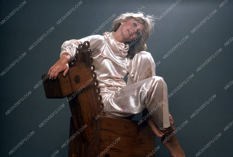 Olivia Newton-John sitting on a rocking horse 35m-5476