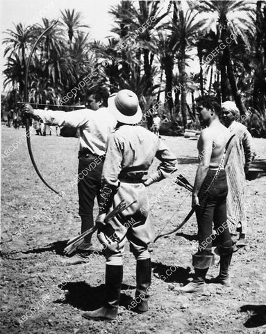 Tyrone Power gets archery tips from John Hopkins on set film The Black Rose 3723-07