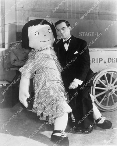 Buster Keaton sitting on lap of huge doll 3899-22