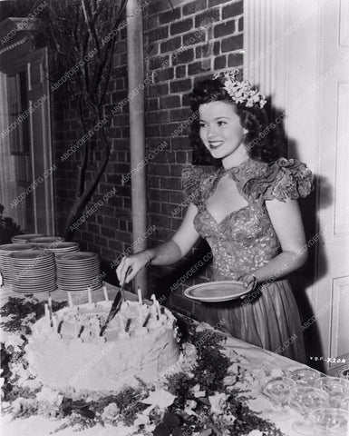 candid Shirley Temple cutting a birthday cake 4439-33