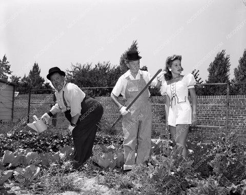 candid Stan Laurel Oliver Hardy tend garden at home in backyard 45bx08-300